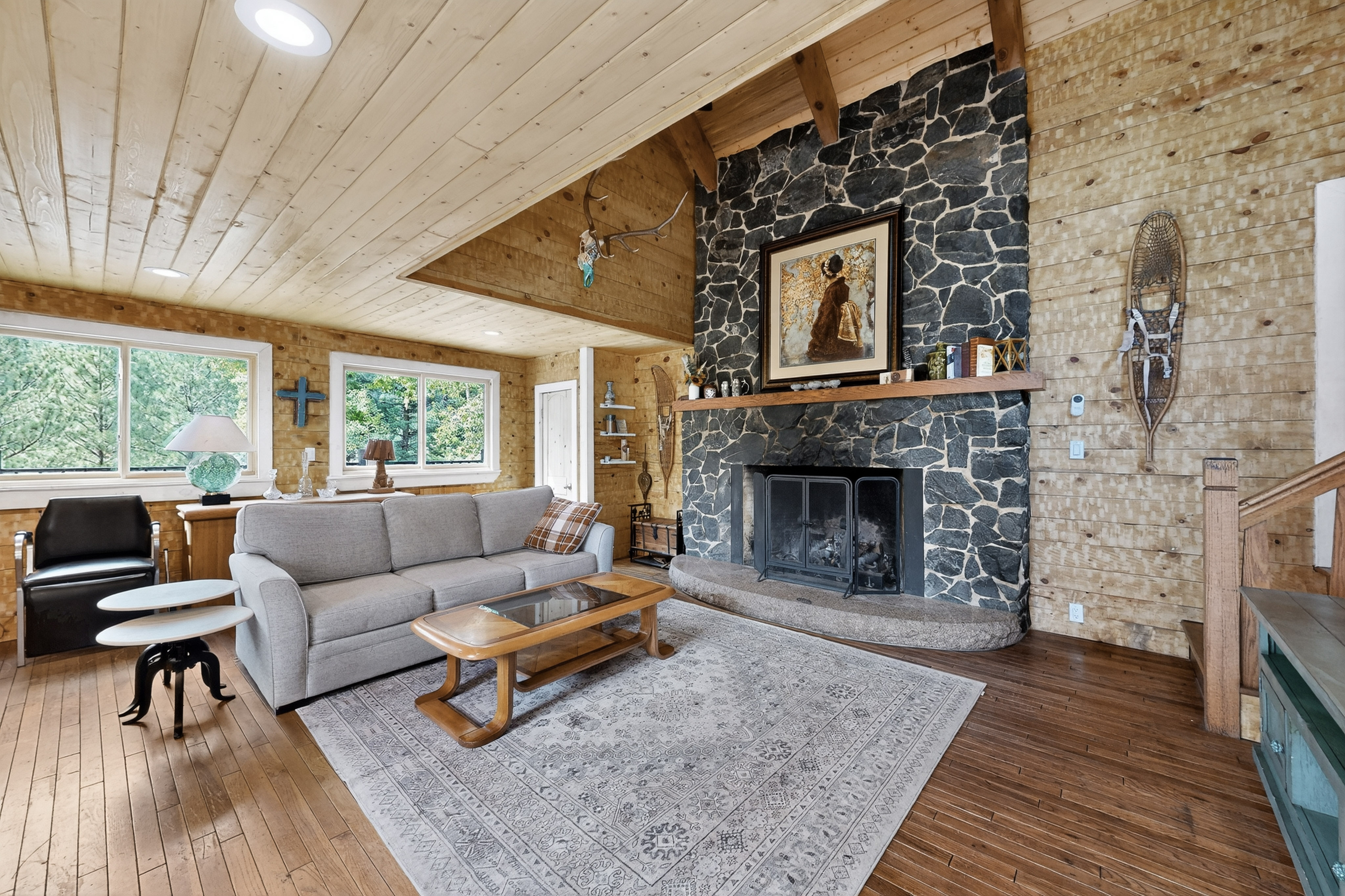 Aspen Elevated Cabin — stone fireplace living room
