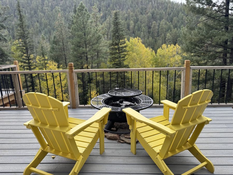 Yellow chairs on the Crestview deck overlooking golden aspens at peak color